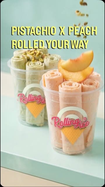 Two branded Rolling Ice cups of pistachio and peach rolled ice cream